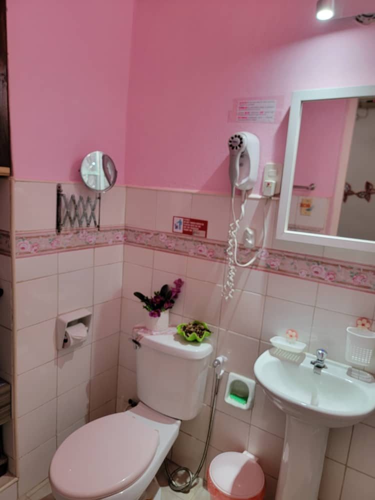 Private bathroom with hairdryer and toiletries