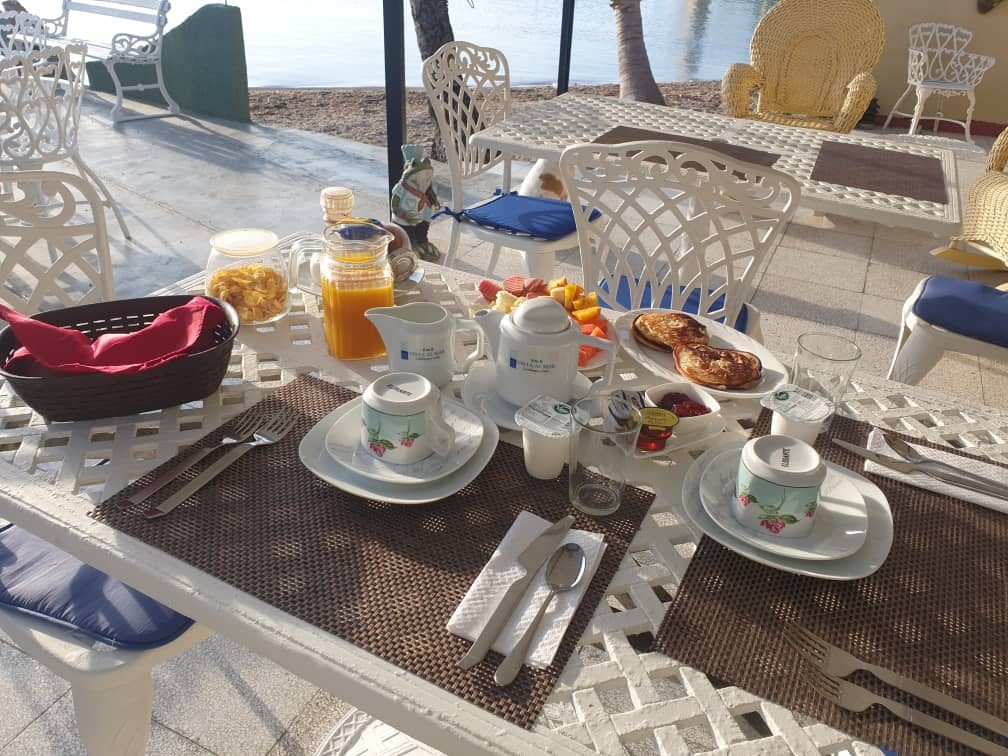 Breakfast table set with fruit, juice and Cuban coffee