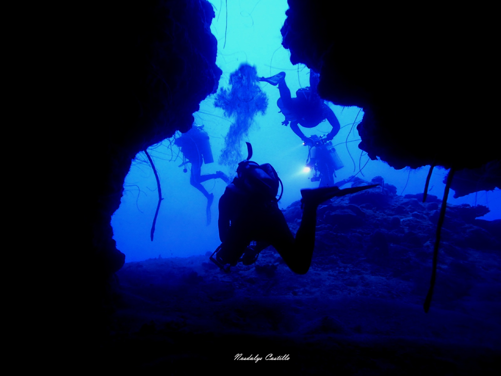 Light beams piercing an underwater cave