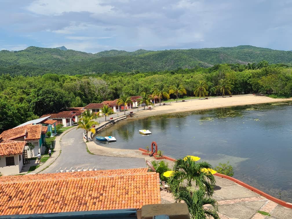 Guajimico eco-lodge: red-roof cabins and natural cove beach