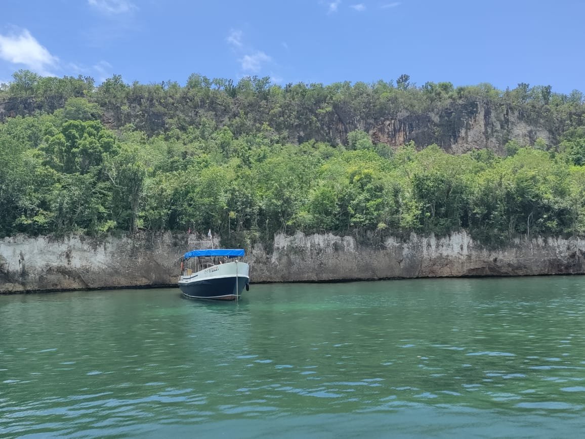 Dive boat anchored in a Guajimico cove